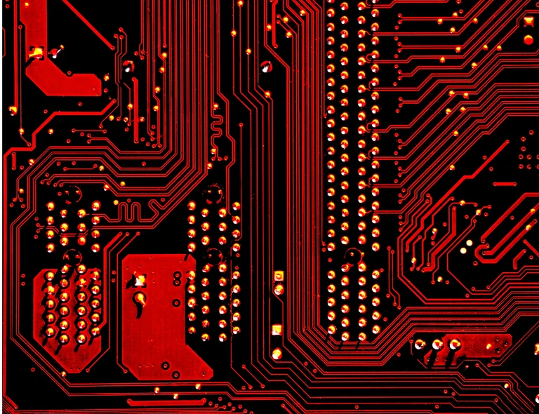Computer motherboard close-view appearing in red and black. 