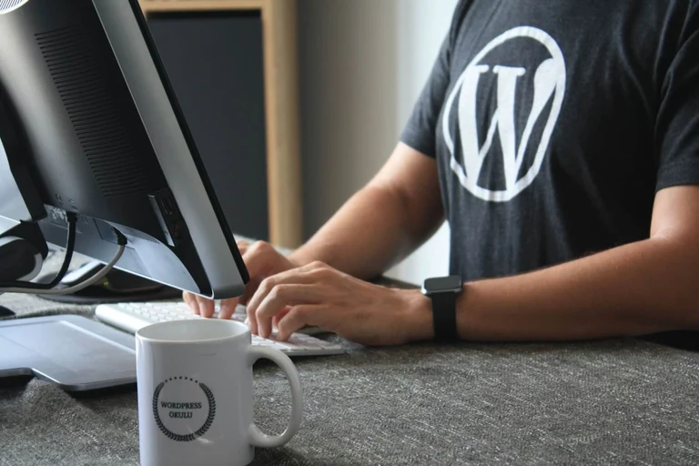 A WordPress WooCommerce Developer is working on code at a desktop computer: