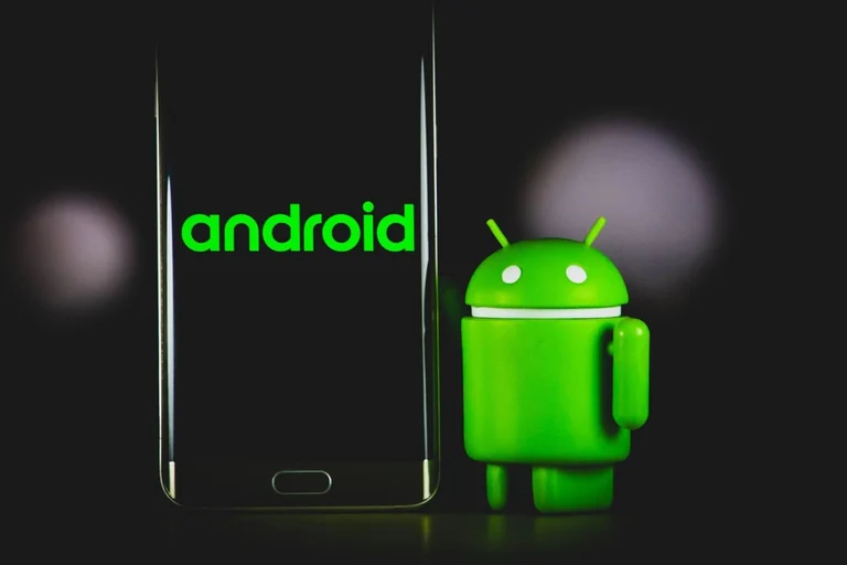 Phone featuring Android logo on black background, with the Android mascot next to it. 