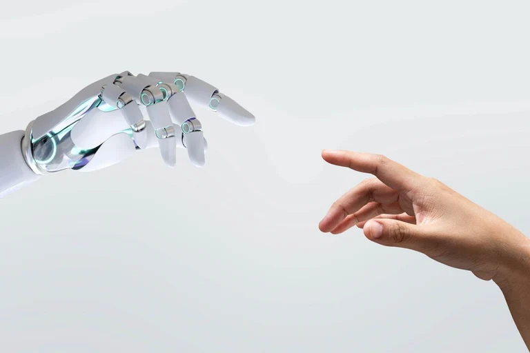 An AI robot hand and a human hand pointing fingers at each other to establish a connection. 