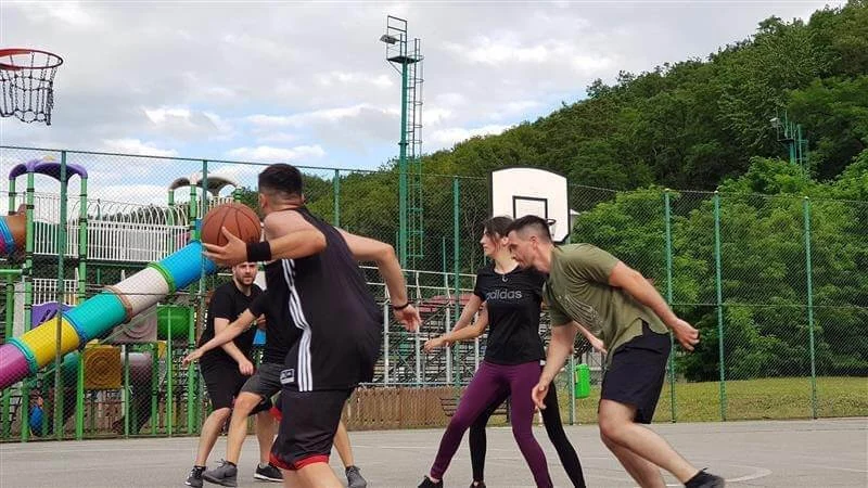 A group of people playing basketball

Description automatically generated