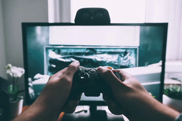 A person is testing a gaming software which is built by a team of entertainment software developers.