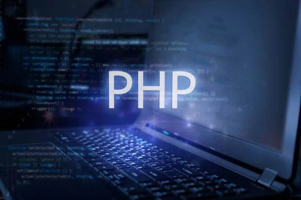 A laptop on a desk with programming codes on the screen. PHP is written boldly on the image