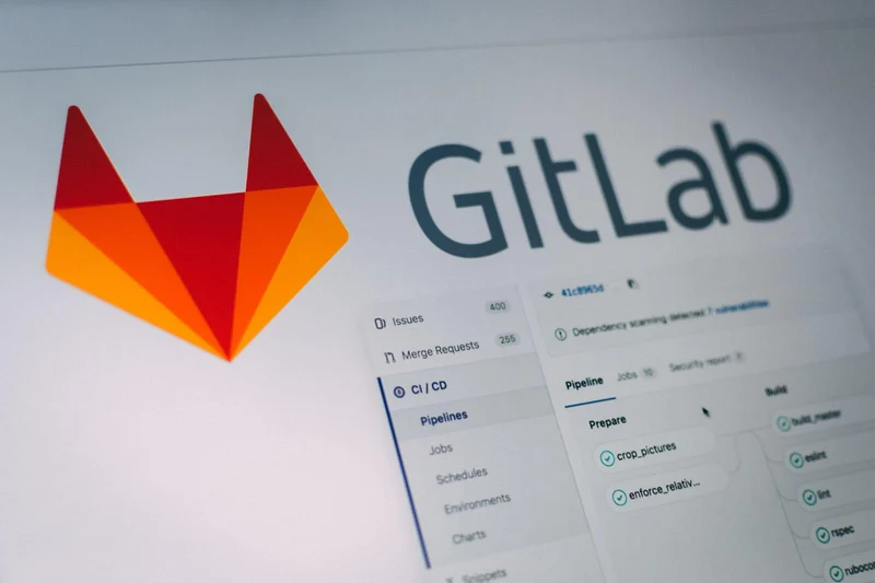 The interface and menu of GitLab are visible, with a minimalist orange logo graphic of a fox to the left of a column of text boxes and options.
