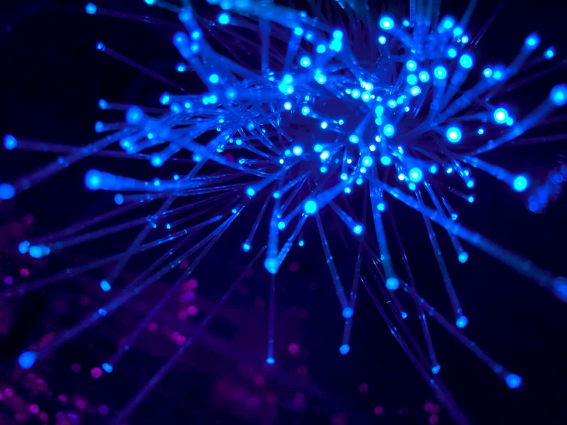 A close-up photograph of glowing blue Internet cables.
