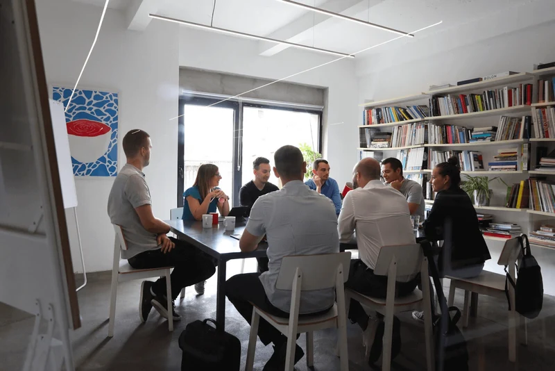 A group of people sitting in an office during a meeting.